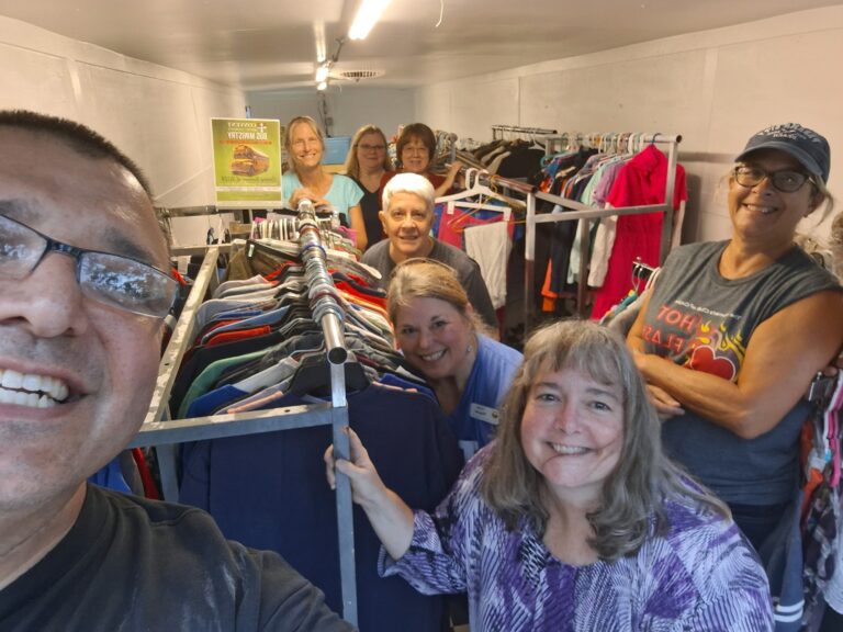 Cyndi, Renee', Lesa, Linda B., Linda W., Mary Jean, Shannon, & Curtis Fink organizing clothes for Godspeed of SC to take to hurricane victims.