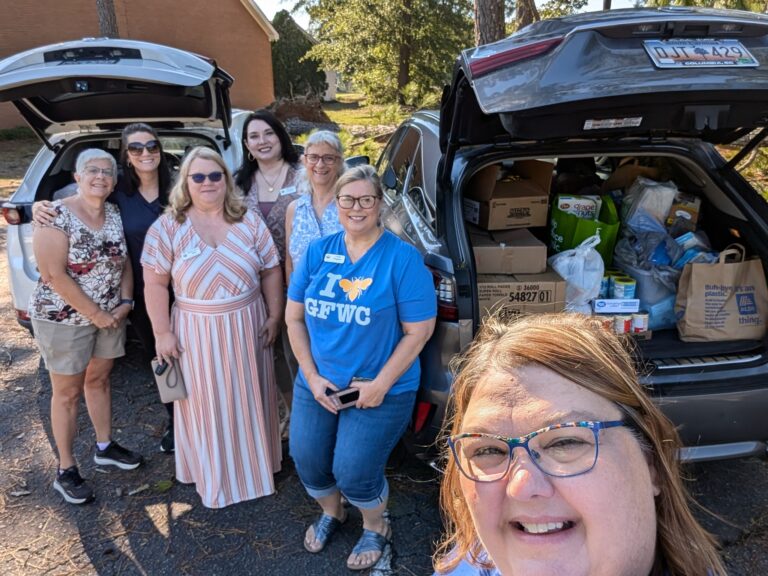 Linda B., Lindsay, Renee', Stephanie, Carol, Linda W., and Susan in front of two carloads of food items to donate to Harvest Hope Food Bank.